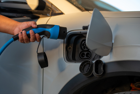 Electric vehicle being plugged into EV Charger