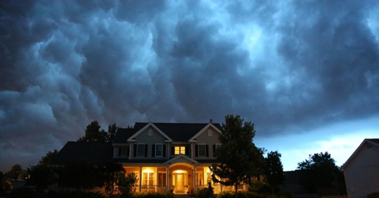 house with lights on in a storm