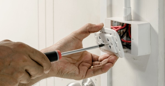 man fixing outlet