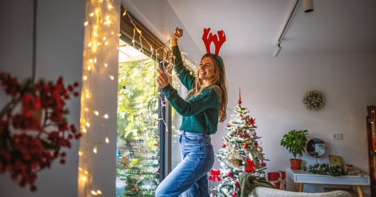 Woman hanging lights.