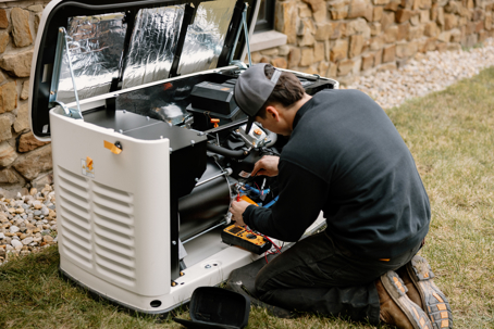 man servicing outdoor generator