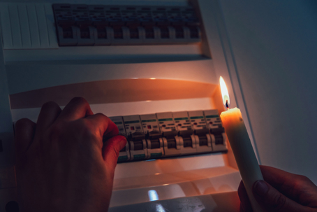 hands checking breaker with candle