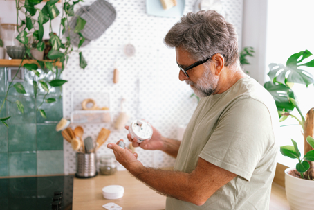 man examining a smoke detector